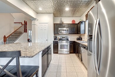 Considerable space between the island and the rest of the kitchen allows this area to function beautifully.