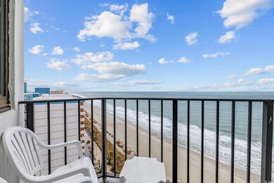 Balcony with a water view and a beach view