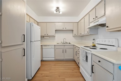 Kitchen with white appliances, under cabinet range