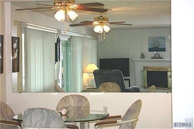 DINING ROOM WITH MORRORED WALL AND CEILING FAN