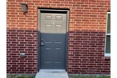 View of exterior entry with brick siding