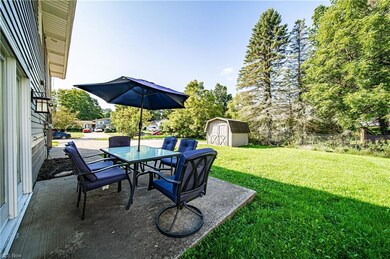 View of patio featuring a storage shed