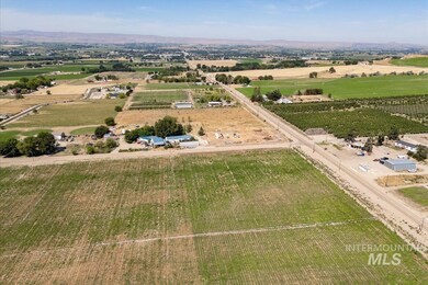 Overview of rural landscape featuring abundant farmland and a mountain backdrop