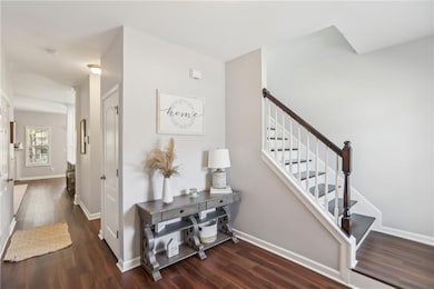 Staircase with wood finished floors and baseboards