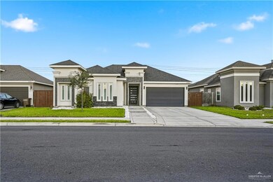 Prairie-style home with driveway, an attached garage, stucco siding, and roof with shingles
