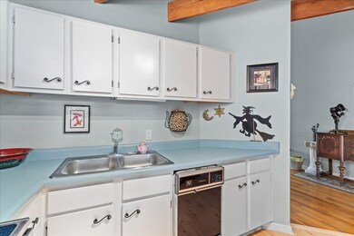Kitchen with sink, light wood-type flooring, white