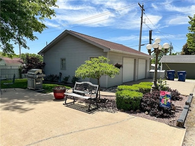 View of side of home with an outbuilding and a patio area