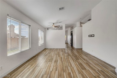 Spare room featuring wood finish floors and a ceiling fan