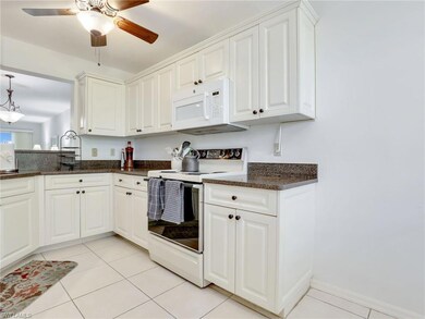 Kitchen featuring ceiling fan, light tile flooring