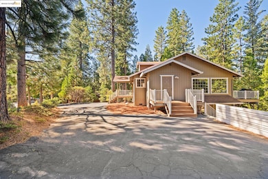 Chalet / cabin with driveway and a wooden deck