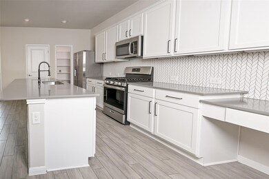 Kitchen featuring appliances with stainless steel