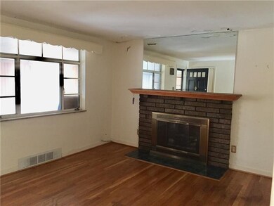 Brick fireplace with wood mantel compliments the h