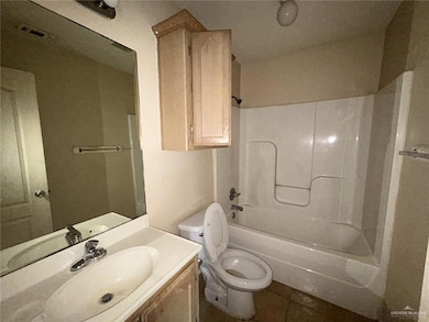 Bathroom featuring bathtub / shower combination, vanity, and tile patterned floors