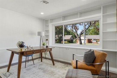 Office space with built in shelves and large windo