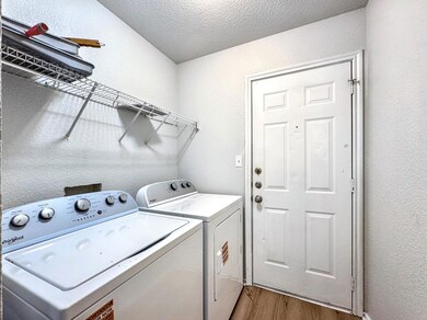 Washroom featuring washing machine and clothes dr