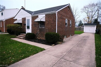 View of front of home featuring a garage and a front yard