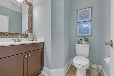 Half bathroom featuring vanity and tile patterned floors