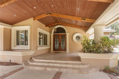 Travertine front porch with wood beam ceiling and 