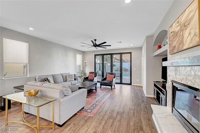 Living area featuring a tiled fireplace, manmade w