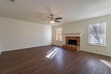 Unfurnished living room featuring dark wood-type f