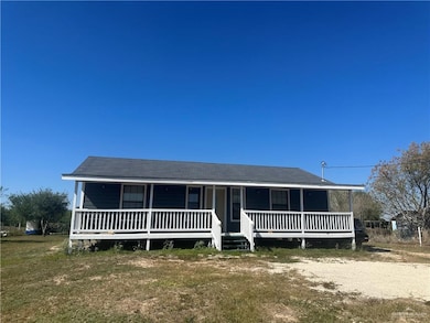 View of front of house featuring covered porch and a front yard
