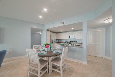 Elegant coastal kitchen featuring white cabinets,