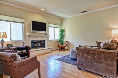 Gleaming hardwood floors and fireplace in living r