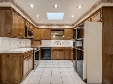 Kitchen with light tile patterned flooring, a skyl