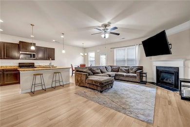 Living room featuring light wood-style flooring, a