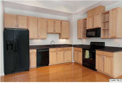 The attractive kitchen features maple cabinets, gr