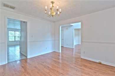 Spare room with wood finished floors, an inviting 