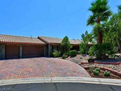 Three car garage with brick pavers on the driveway