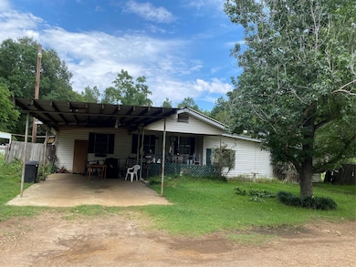 Rear view of house featuring a lawn