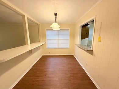 Unfurnished dining area with ornamental molding, d