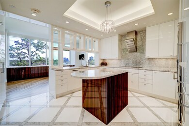 The kitchen has marble countertops, gorgeous lacqu