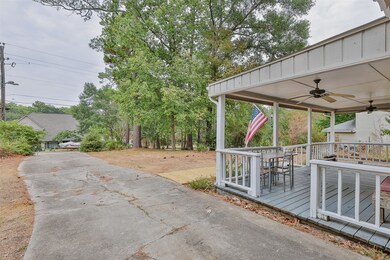 Extended driveway with side access to covered porc