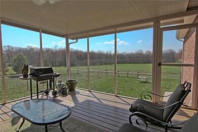 Enjoy the view of your back yard from this covered/screened in deck