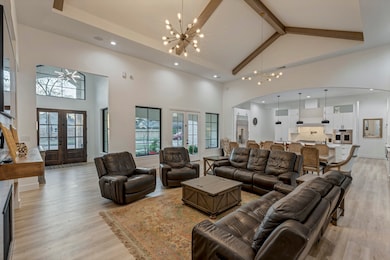 This spacious living area features high vaulted ce