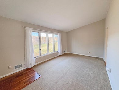 Living room with large windows and door to back yard.