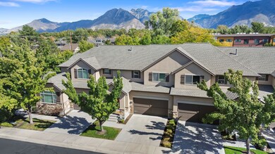 View of front of house with stone siding, concrete driveway, a garage, and stucco siding