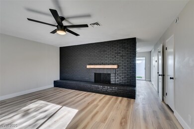 Unfurnished living room with visible vents, wood f