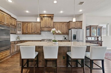Kitchen featuring light stone counters, appliances