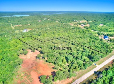 View of property location featuring a heavily wooded area and property parcel outlined