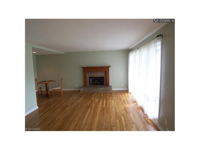 Living room with hardwood floors gas fireplace.