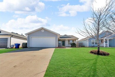 Ranch-style home featuring concrete driveway, an a