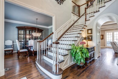 Staircase with a notable chandelier, crown molding