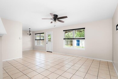 Unfurnished room with a chandelier, a ceiling fan