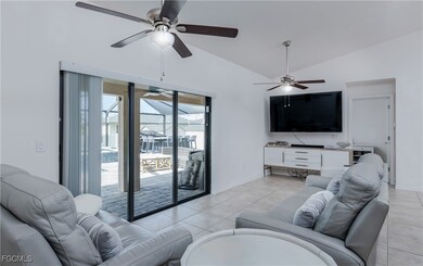 Living area with a ceiling fan, light tile pattern