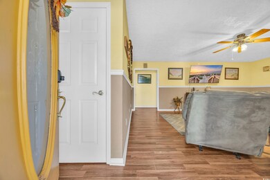 Interior space with ceiling fan, a textured ceilin