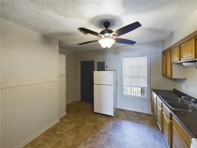 Kitchen featuring freestanding refrigerator, dark